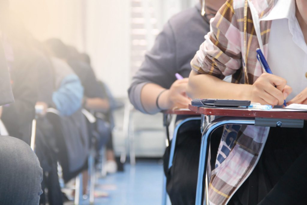 high school students working at desks in classroom