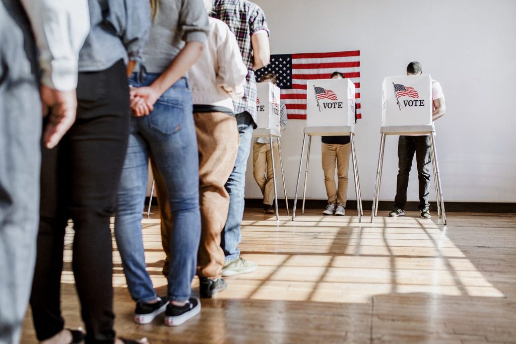 voters waiting in line and voting
